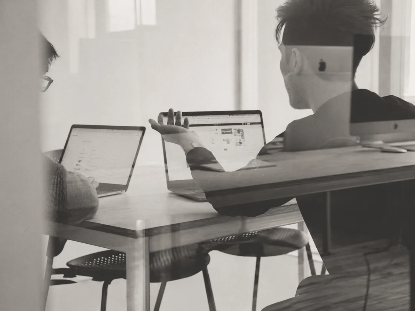 Researchers working together at desks in a quiet office setting